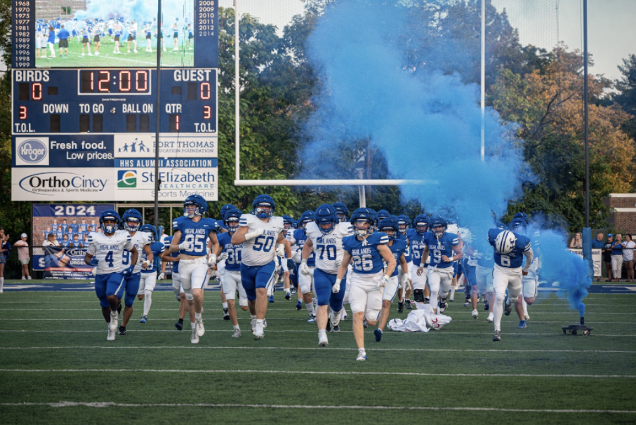 The Highlands Football Team runs out to start the Blue-White Scrimmage.
